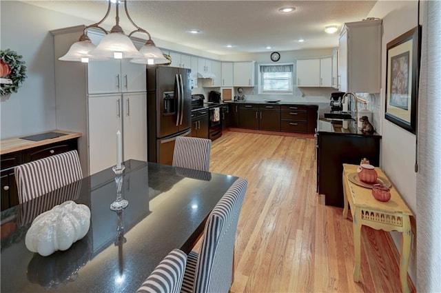 dining space featuring sink and light hardwood / wood-style flooring