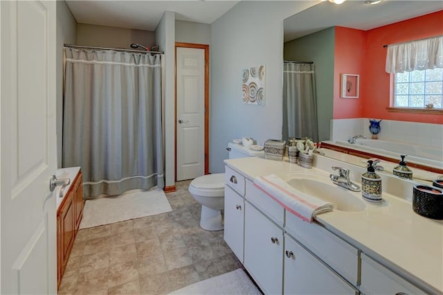 bathroom with a bathing tub, vanity, and toilet