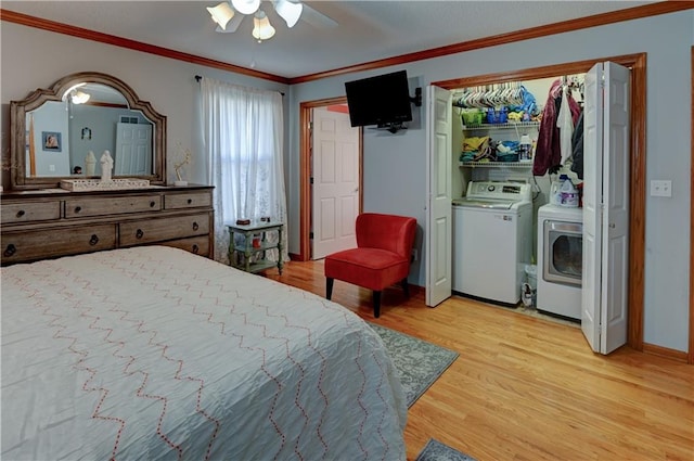 bedroom featuring separate washer and dryer, ceiling fan, light hardwood / wood-style flooring, and ornamental molding