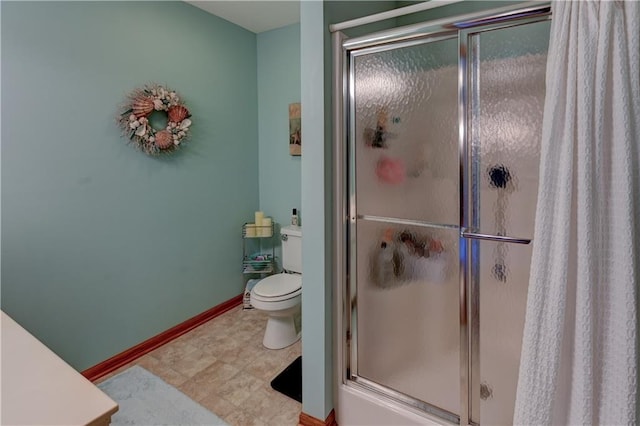 bathroom featuring toilet and walk in shower