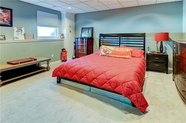 carpeted bedroom with a paneled ceiling