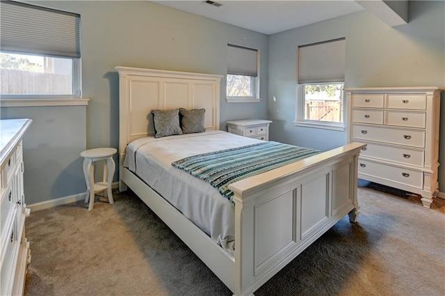 carpeted bedroom featuring multiple windows