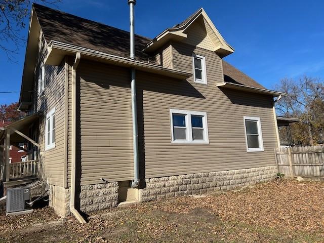 view of side of home featuring cooling unit