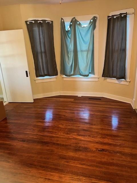 unfurnished room with hardwood / wood-style floors