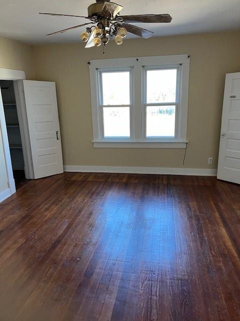 unfurnished room featuring ceiling fan and dark hardwood / wood-style flooring