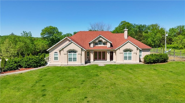 rear view of property with a yard