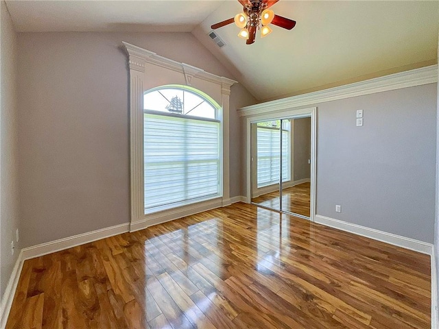 unfurnished room with hardwood / wood-style flooring, ceiling fan, and lofted ceiling