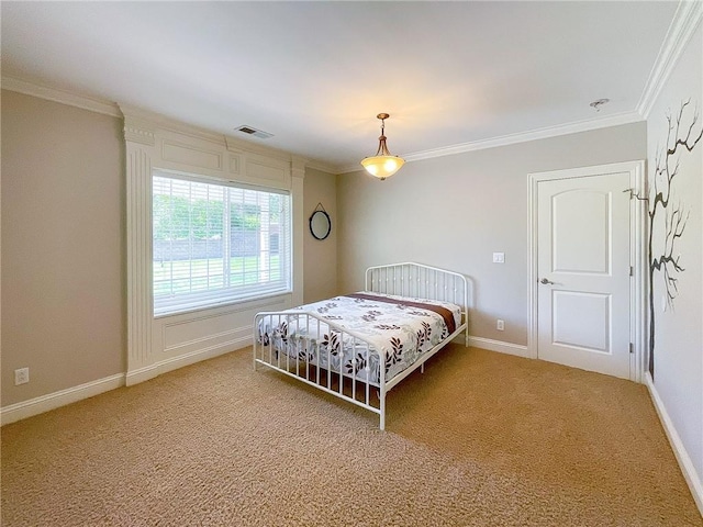 carpeted bedroom with ornamental molding