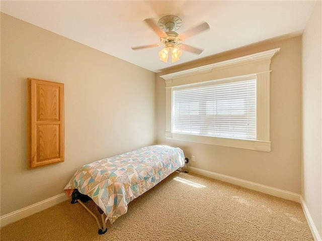 bedroom featuring ceiling fan and carpet