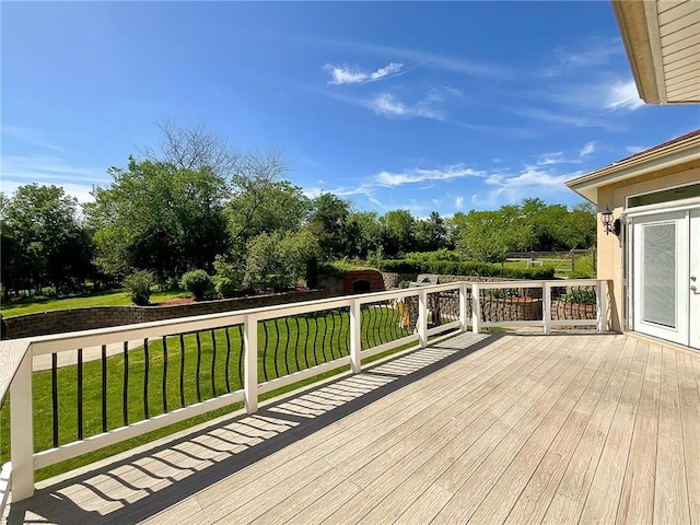 wooden terrace with a lawn