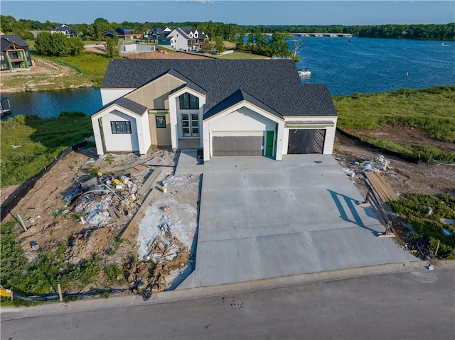 16 Checotah Bluffs Cir, Lake Winnebago, MO 64034 - view of front of property featuring a garage, a water view, and driveway