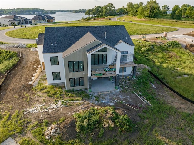 16 Checotah Bluffs Cir, Lake Winnebago, MO 64034 - rear view of house featuring roof with shingles, a balcony, and a patio area