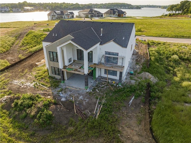 16 Checotah Bluffs Cir, Lake Winnebago, MO 64034 - back of property featuring roof with shingles, a water view, and a patio area