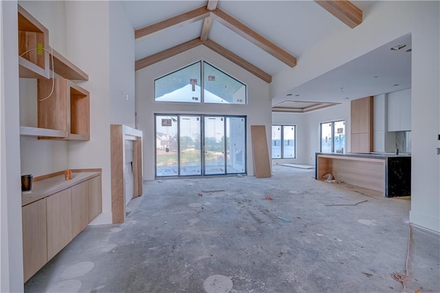 16 Checotah Bluffs Cir, Lake Winnebago, MO 64034 - unfurnished living room with high vaulted ceiling and beamed ceiling