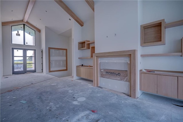 16 Checotah Bluffs Cir, Lake Winnebago, MO 64034 - unfurnished living room with high vaulted ceiling, beamed ceiling, and french doors