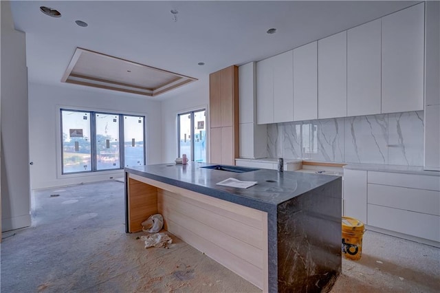 16 Checotah Bluffs Cir, Lake Winnebago, MO 64034 - kitchen with modern cabinets, a tray ceiling, and white cabinetry