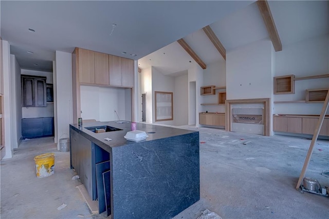 16 Checotah Bluffs Cir, Lake Winnebago, MO 64034 - kitchen featuring modern cabinets, light brown cabinets, and an island with sink