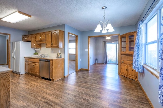 kitchen featuring dishwasher, plenty of natural light, and dark wood-type flooring