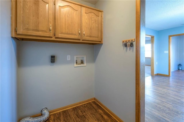 laundry area featuring hookup for a washing machine, cabinets, and light wood-type flooring