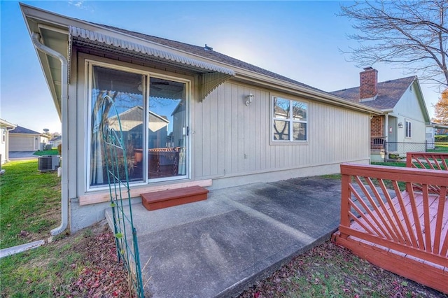 rear view of property featuring central AC unit