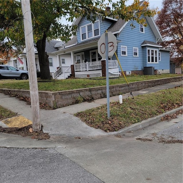 view of front of home with covered porch and central air condition unit