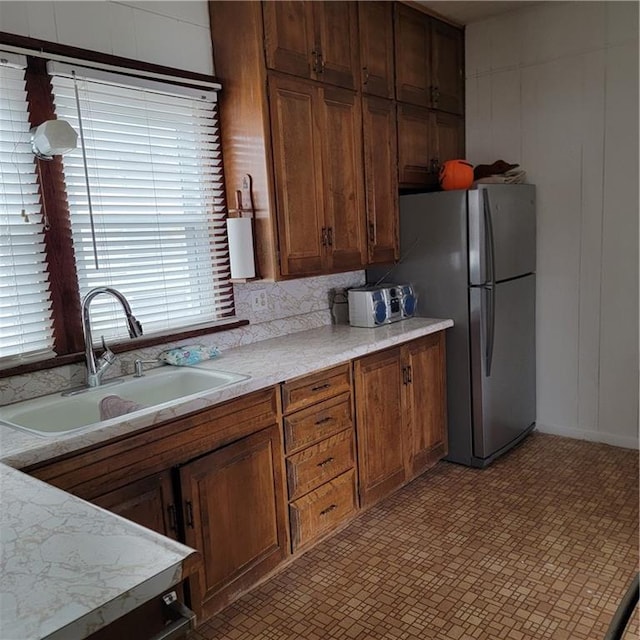 kitchen with stainless steel fridge and sink