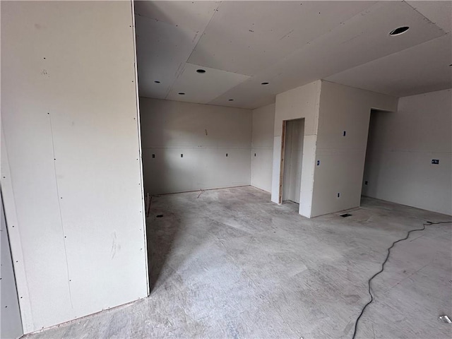 empty room with unfinished concrete flooring