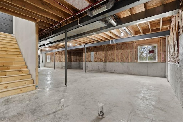 basement featuring stairway and electric panel
