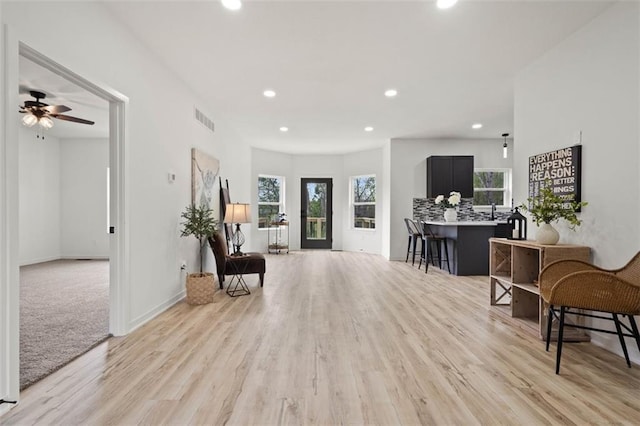 interior space featuring light wood finished floors, visible vents, and recessed lighting