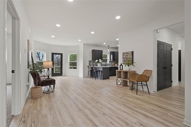 interior space with recessed lighting, light wood-type flooring, and baseboards
