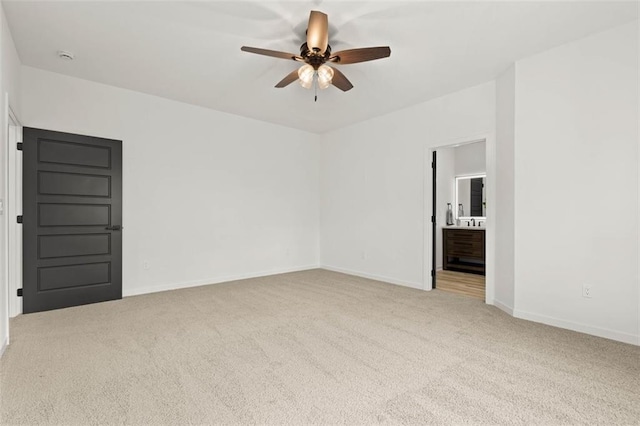 carpeted empty room featuring baseboards and ceiling fan