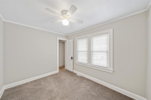 unfurnished bedroom with ceiling fan, carpet, and ornamental molding