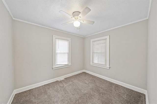 carpeted empty room featuring a textured ceiling, ceiling fan, and crown molding