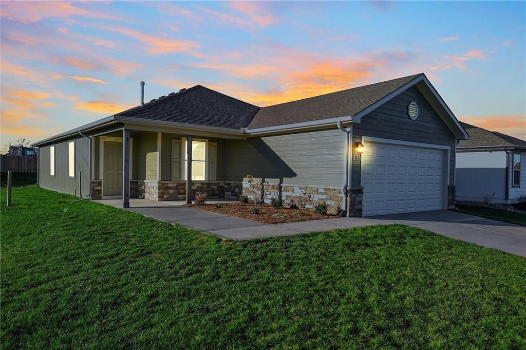 ranch-style house with a lawn and a garage