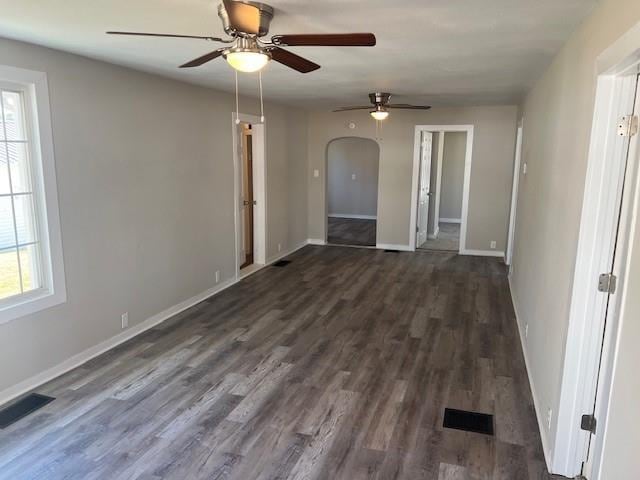 spare room with ceiling fan and dark wood-type flooring