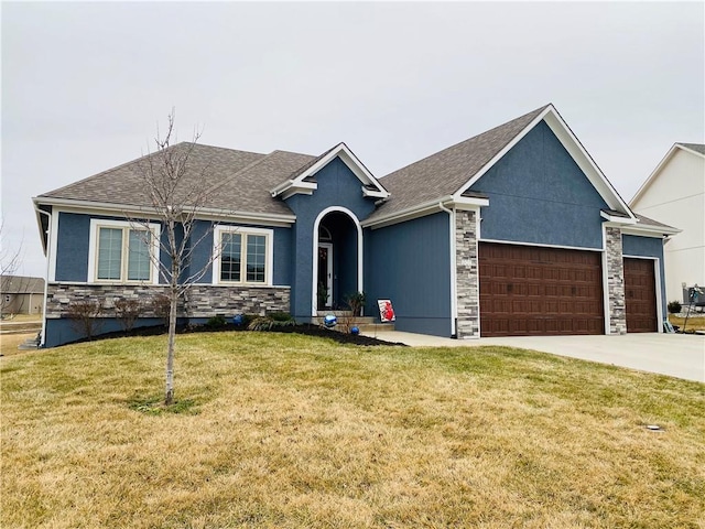 view of front of house with a garage and a front yard