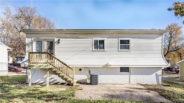 rear view of house with central AC unit