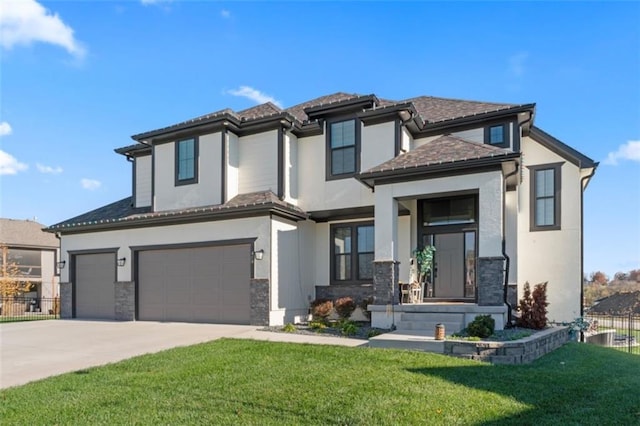 view of front of property featuring a garage and a front lawn