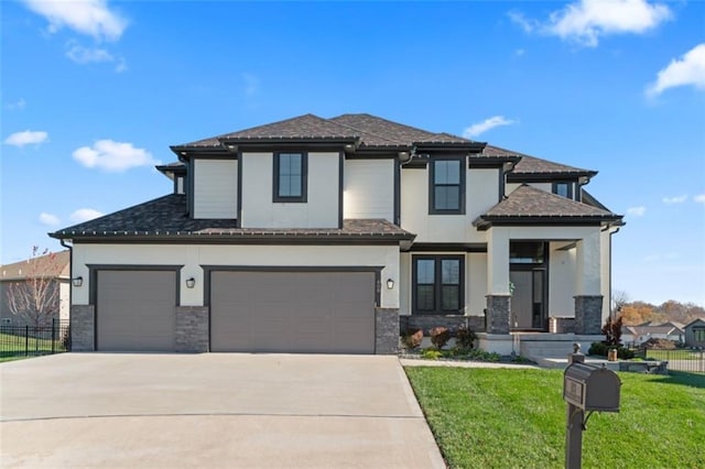 view of front of house with a front lawn and a garage