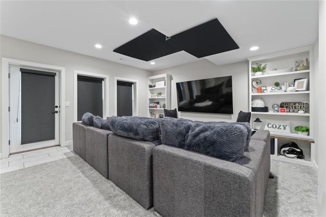 home theater room featuring light tile patterned floors and built in features