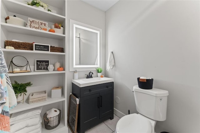 bathroom featuring tile patterned flooring, vanity, and toilet