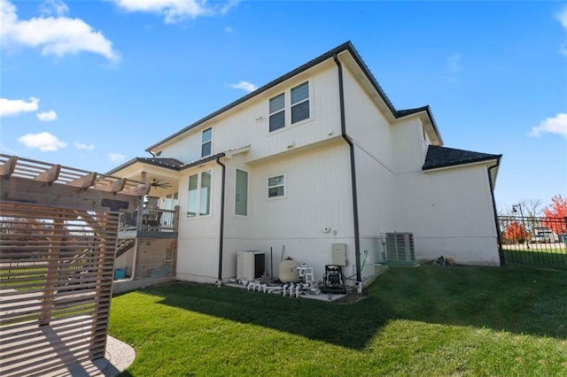 back of property featuring a yard, a pergola, and central air condition unit