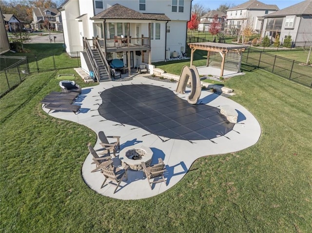 back of house with a yard, an outdoor fire pit, a patio area, and a wooden deck