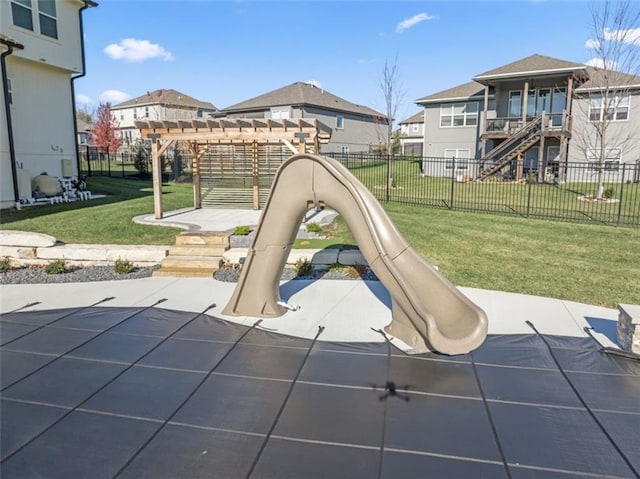 view of play area with a pergola and a yard