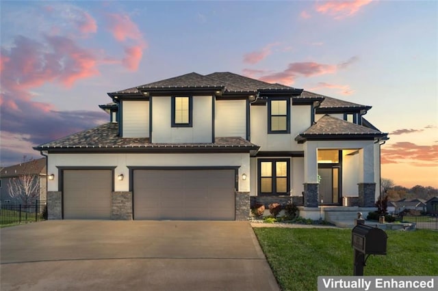 view of front of property with a garage and a lawn