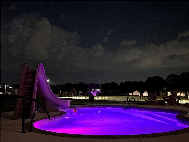 view of pool at night