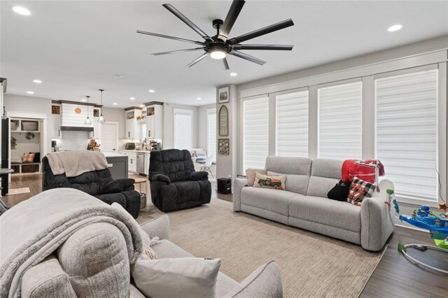 living room featuring ceiling fan and light wood-type flooring