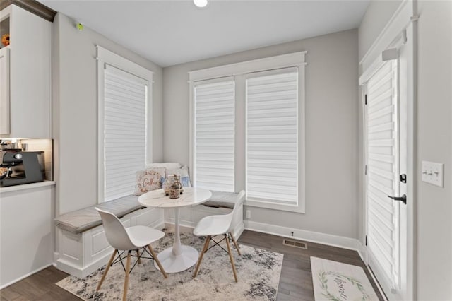 dining space with breakfast area and dark hardwood / wood-style floors