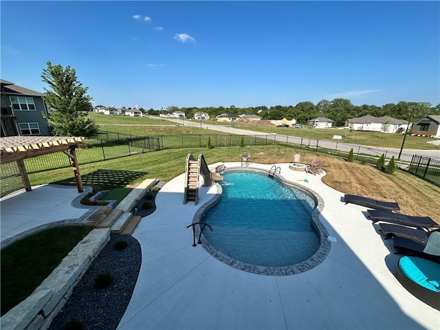 view of swimming pool featuring a yard and a patio