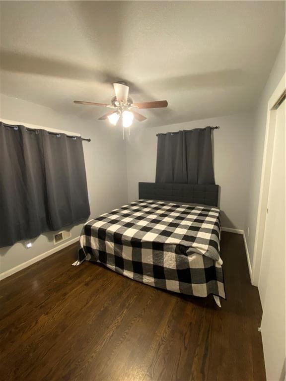 bedroom featuring ceiling fan and dark wood-type flooring